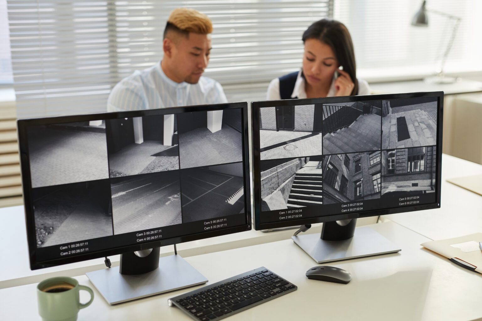 Background image two computer screens with multiple surveillance camera feeds